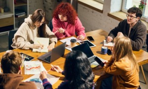 What Long Beach can teach communities about youth participatory budgeting_feature: group of young people collaborating around wooden table with laptops and charts