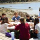 Young people need more than safer screens_feature: group of young people at table on coastline