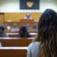 Juvenile justice reform should start with decisions young people can understand_feature: young female offender sits in judicial room with several others