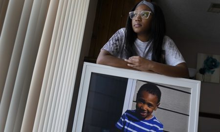 gun violence killing teens, children: young mother holding picture of dead son
